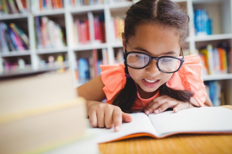 Little girl reading a book