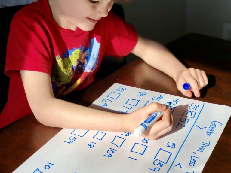 Kindergarten boy doing math work for homeschool